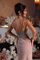 Woman in silver and nude sequin gown