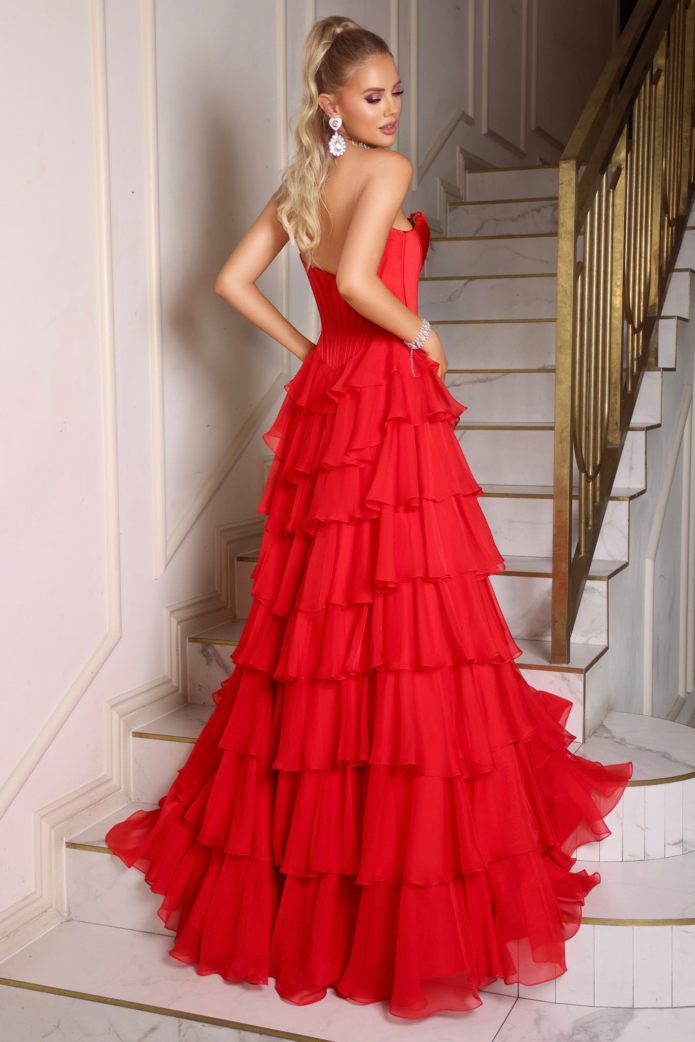 Red tiered evening gown on stairs