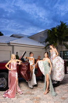 Girls in gowns by classic car