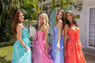 Four women in XO170 pastel prom dresses