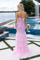 Woman in pink formal dress by pool